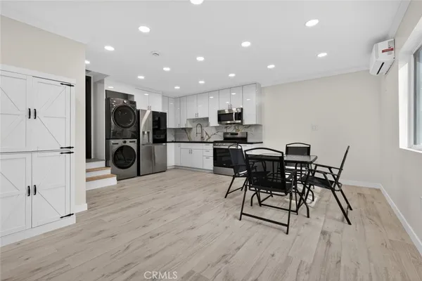 a kitchen with stainless steel appliances granite countertop a refrigerator and a stove top oven
