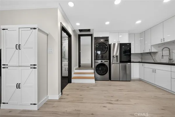 a kitchen with a stove top oven sink and cabinets