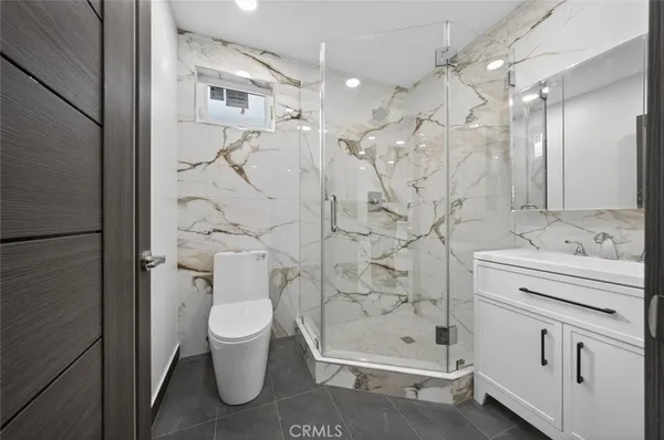 a kitchen with stainless steel appliances granite countertop a stove top oven a sink a dining table and chairs