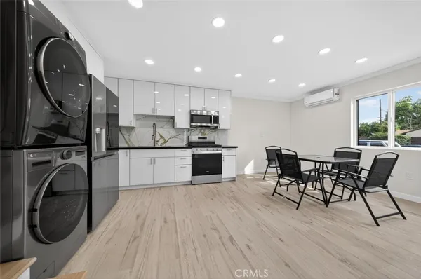 a kitchen with stainless steel appliances granite countertop a stove a sink and a refrigerator