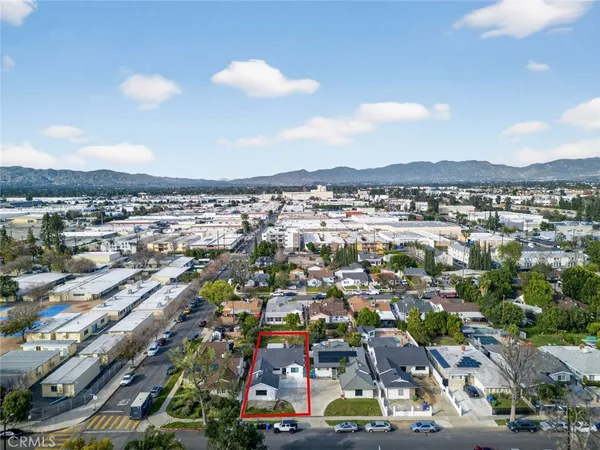 an aerial view of residential houses with city view