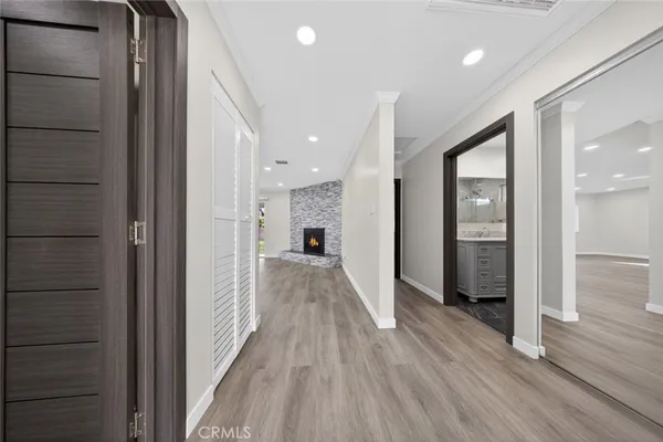 a view of a hallway with wooden floor and staircase