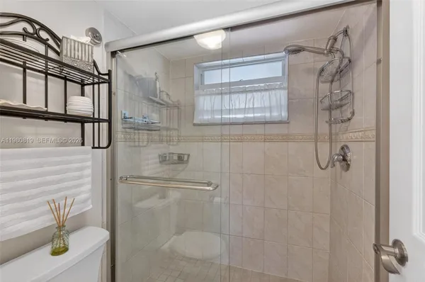 a bathroom with a shower and a toilet