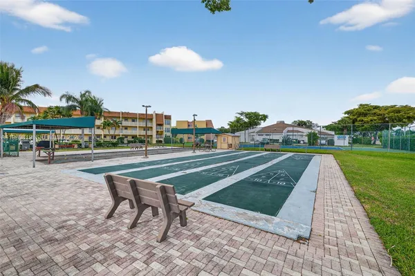 a view of a patio with table and chairs