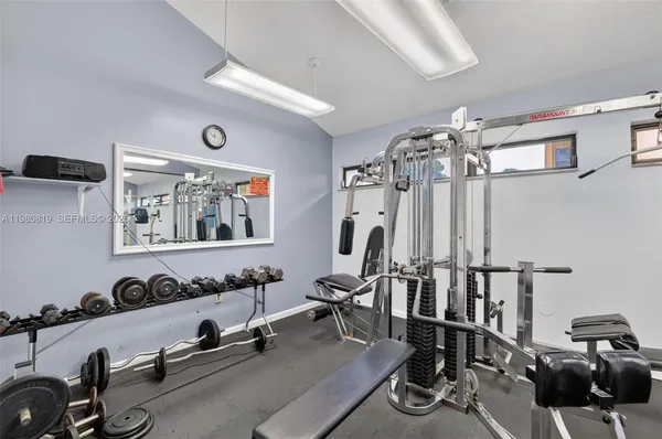 a view of a patio with table and chairs potted plants and a large tree