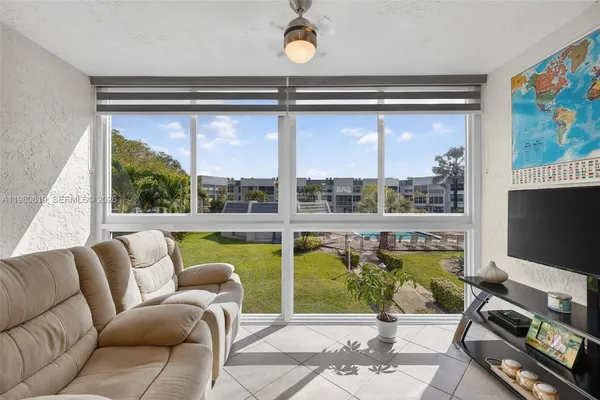a living room with furniture tv and a large window