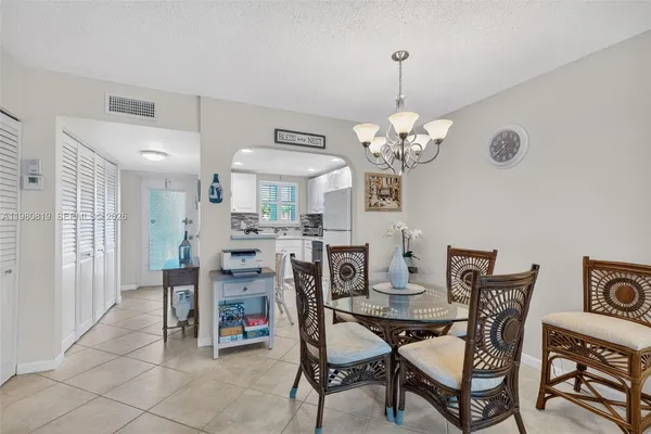 a view of a dining room with furniture and chandelier