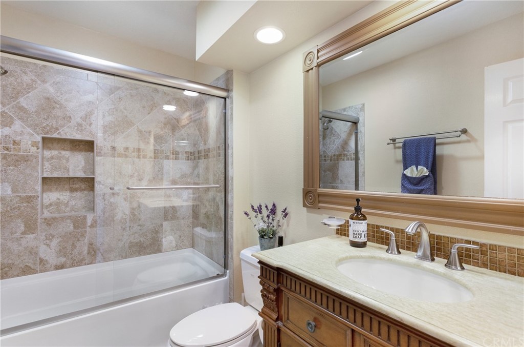 20 Stream Street Laguna Niguel, CA 92677 - Photo 13 of 28 a bathroom with a granite countertop tub sink toilet and mirror