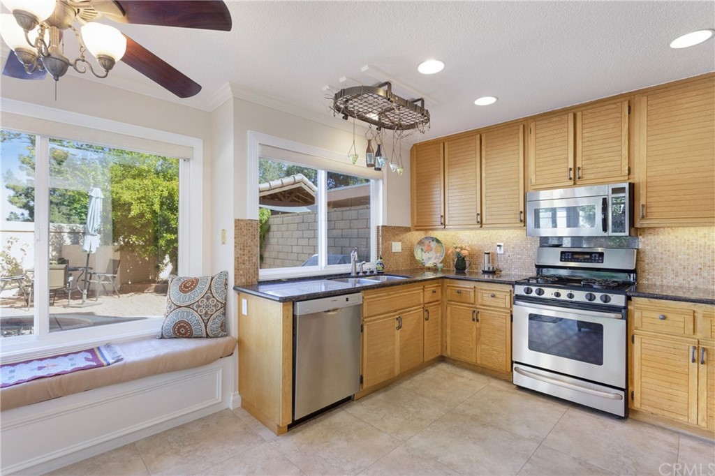 20 Stream Street Laguna Niguel, CA 92677 - Photo 4 of 28 a kitchen with stainless steel appliances granite countertop a stove and a sink