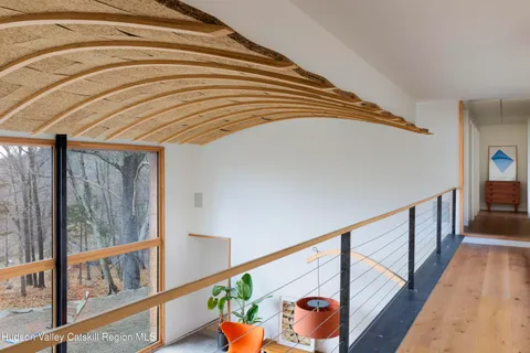 a bedroom with a bed and painting on the wall