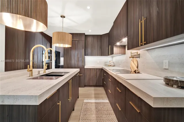 a kitchen with stainless steel appliances a dining table chairs refrigerator and stove