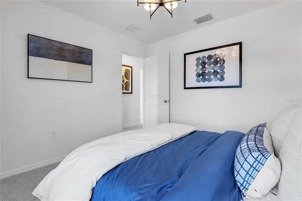 a bedroom with a bed and a potted plant