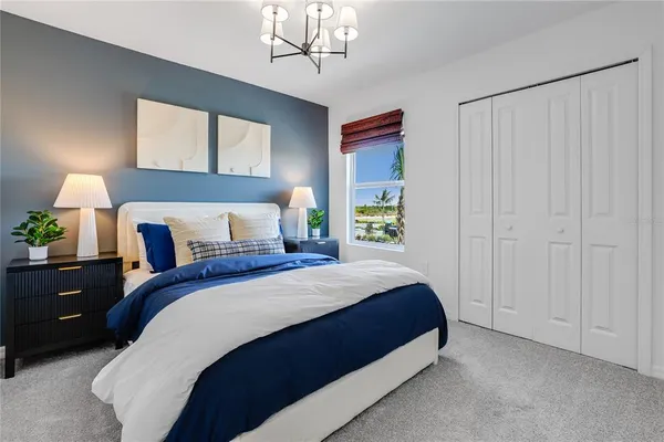 a bedroom with bed and a potted plant