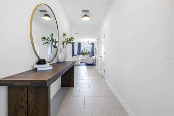 a hallway with a sink and a mirror