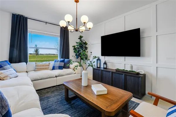 a living room with furniture and a flat screen tv