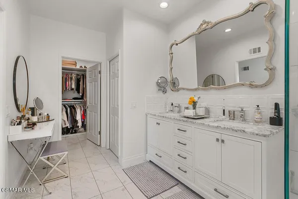 a bedroom with a bed and a potted plant