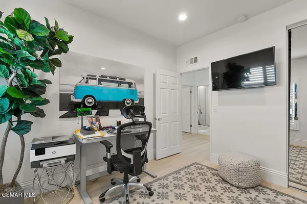 a bathroom with a granite countertop toilet a sink and mirror