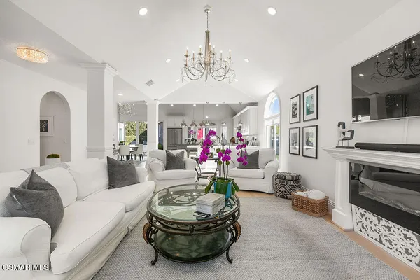 a living room with furniture and a chandelier