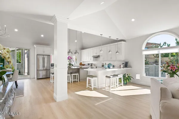 a large kitchen with a table and chairs