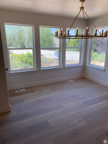 4676 West 75 North, Unit 401 West Point, UT 84015 - Photo 20 of 25 Spacious room featuring a contemporary brass chandelier with multiple exposed bulbs
