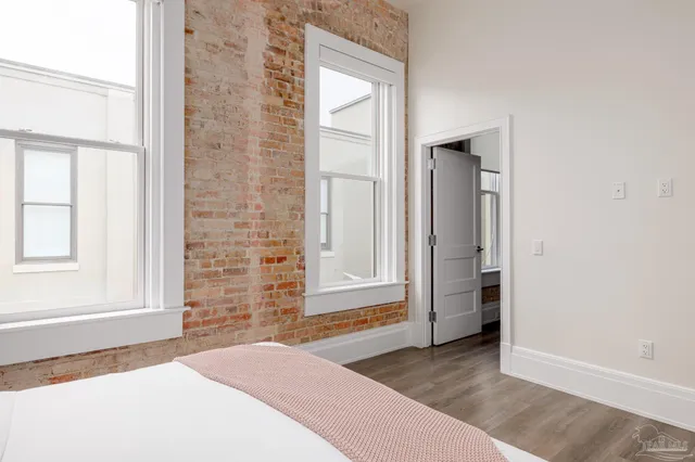 an empty room with windows and closet