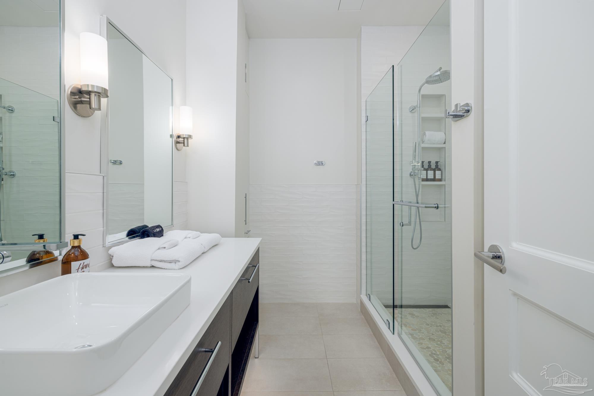 17 Palafox Place, Unit 307 Pensacola, FL 32502 - Photo 13 of 27 a bathroom with a sink and a mirror