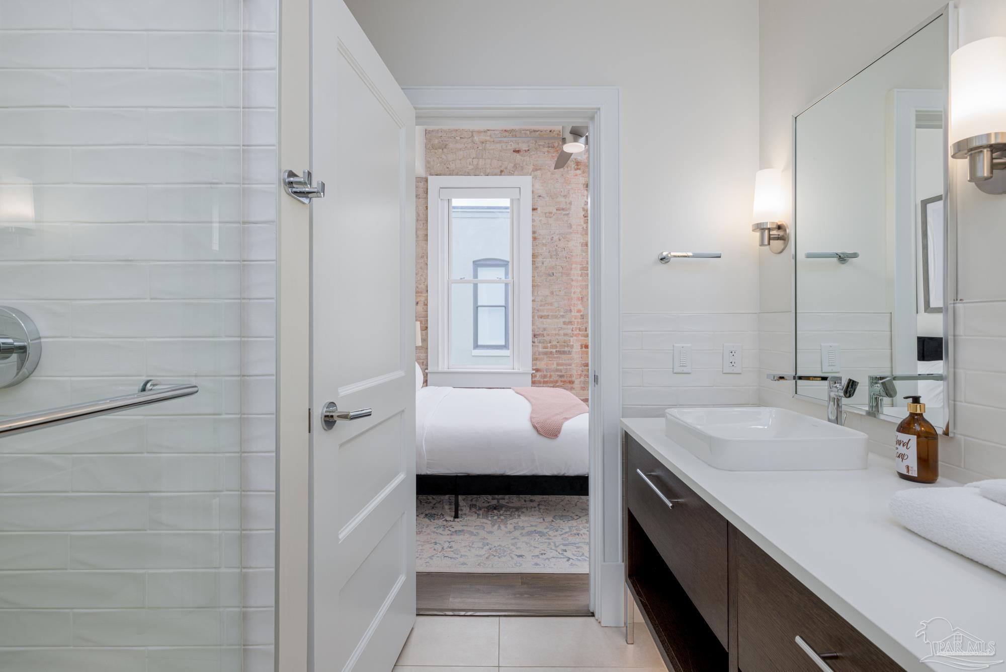 17 Palafox Place, Unit 307 Pensacola, FL 32502 - Photo 14 of 27 a bathroom with a sink and a mirror