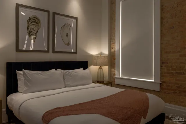 a bedroom with a bed and wall painting