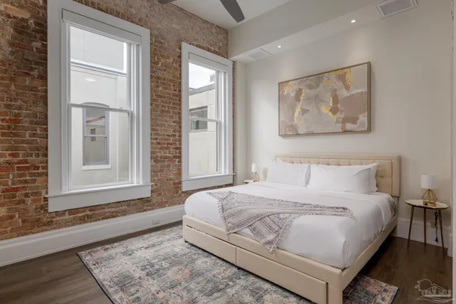 a bedroom with a bed and a painting on the wall