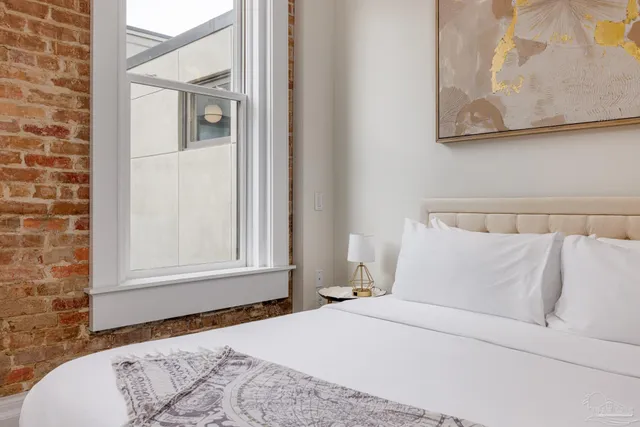 a bedroom with a bed and a window