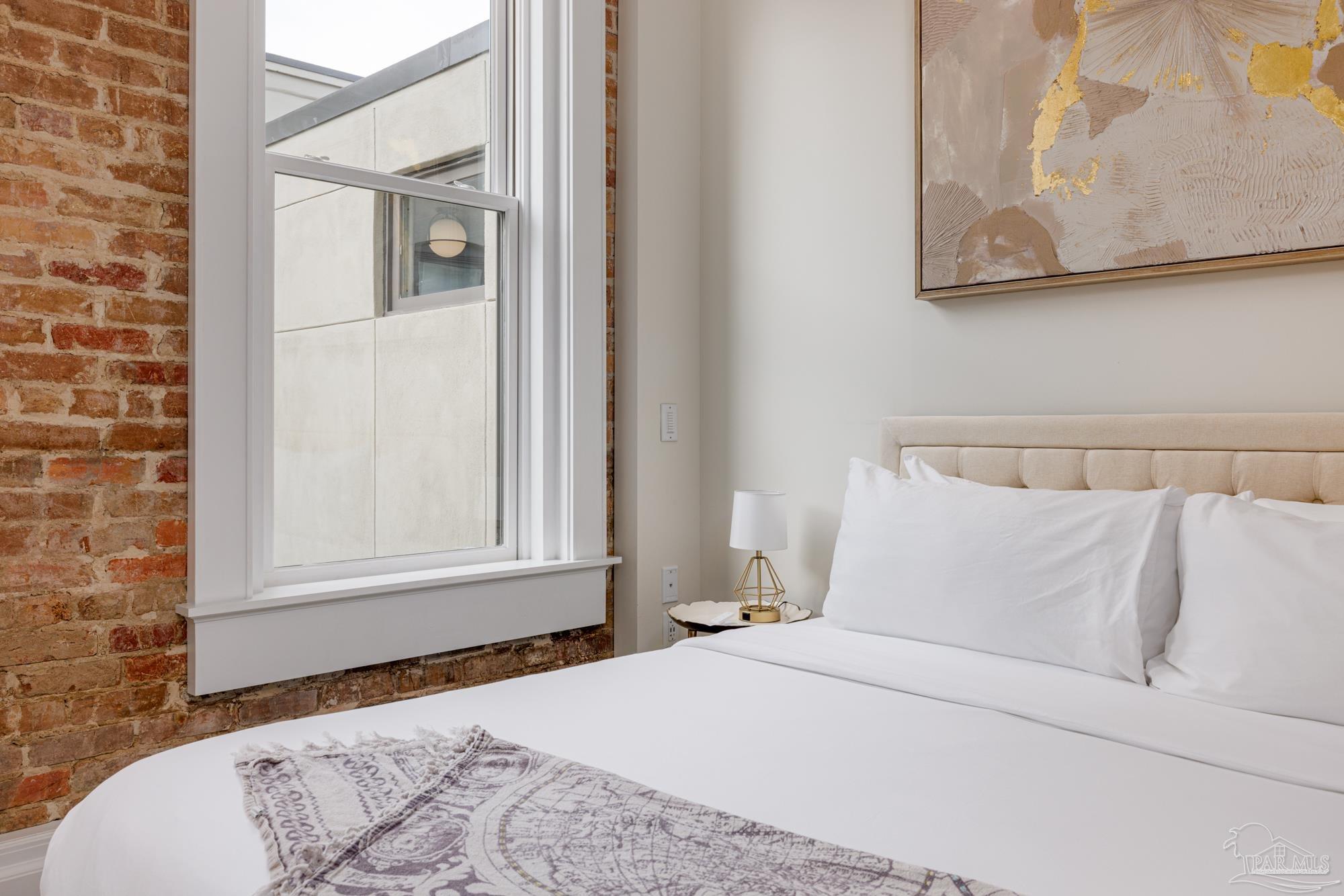 17 Palafox Place, Unit 307 Pensacola, FL 32502 - Photo 18 of 27 a bedroom with a bed and a window