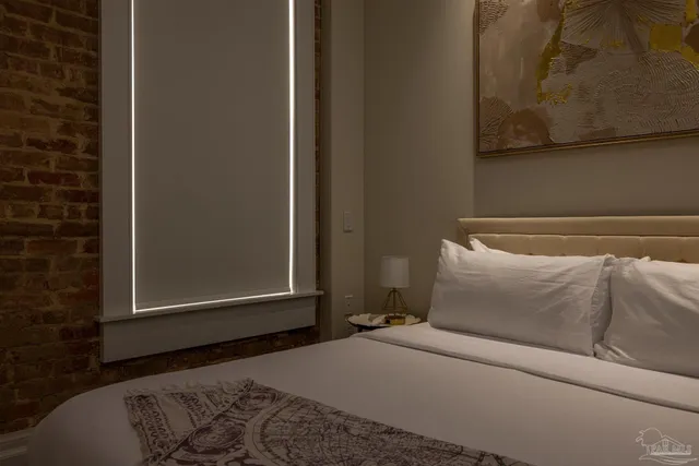 a bedroom with a bed and wall painting