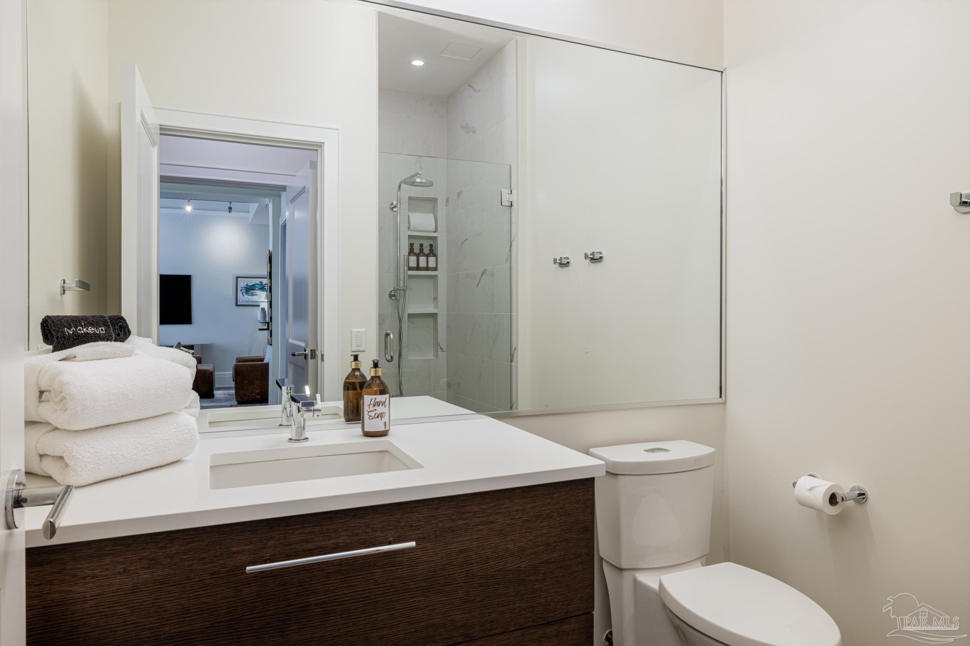 17 Palafox Place, Unit 307 Pensacola, FL 32502 - Photo 21 of 27 a bathroom with a sink toilet and mirror
