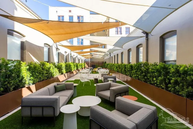 a view of a patio with couches chairs and a potted plant