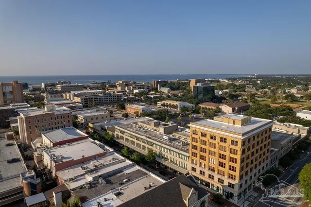 an aerial view of a multi story parking building with outdoor space