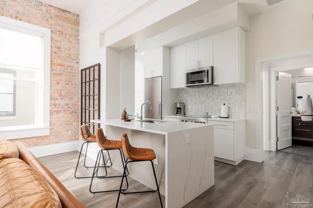 a kitchen with stainless steel appliances a sink and a refrigerator