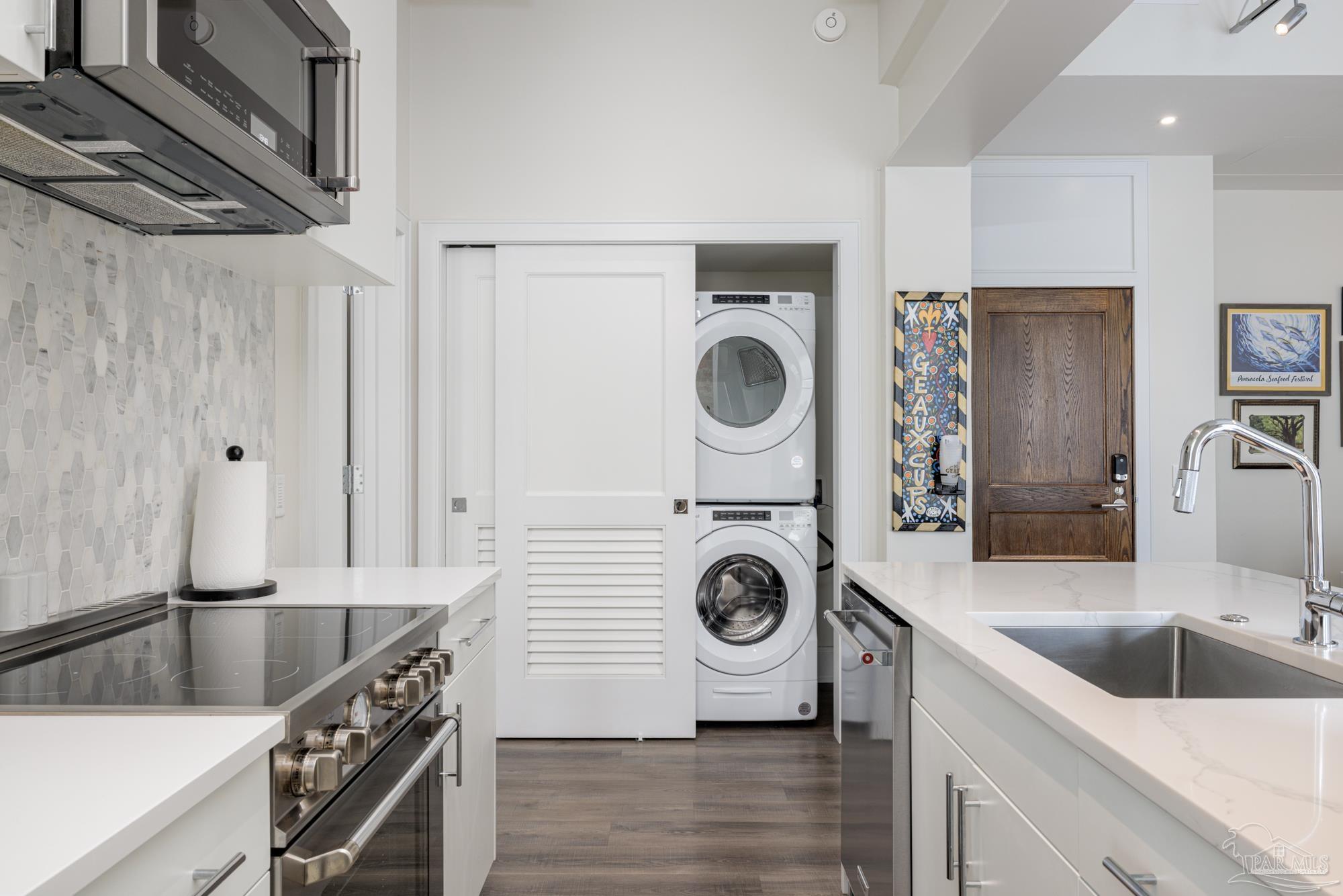 17 Palafox Place, Unit 307 Pensacola, FL 32502 - Photo 7 of 27 a kitchen with a stove sink and a refrigerator