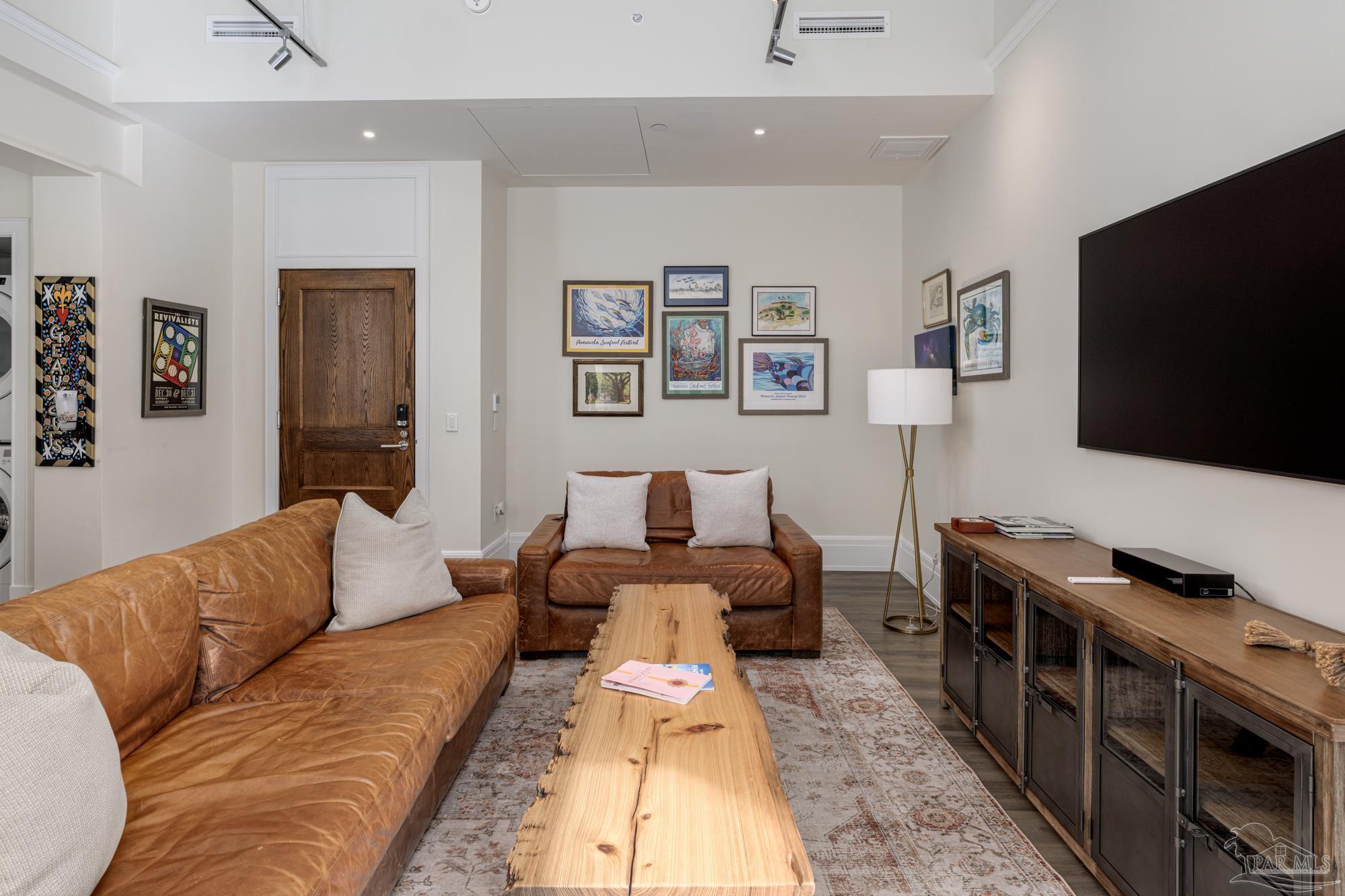 17 Palafox Place, Unit 307 Pensacola, FL 32502 - Photo 9 of 27 a living room with furniture and a flat screen tv