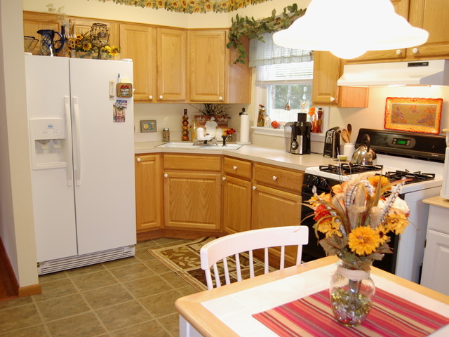 686 Walnut Road Wauconda, IL 60084 - Photo 6 of 21 a kitchen with stainless steel appliances a refrigerator a sink a stove and white cabinets