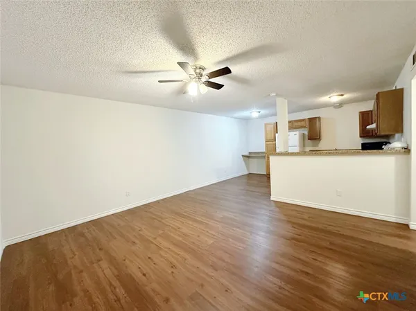 a view of a kitchen with a dishwasher and wooden floor