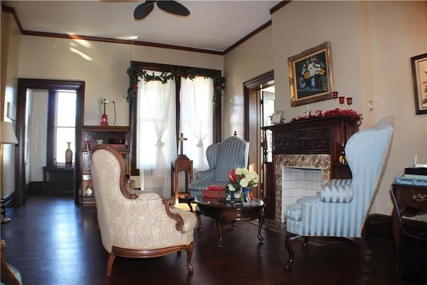 a living room with furniture a fireplace and windows