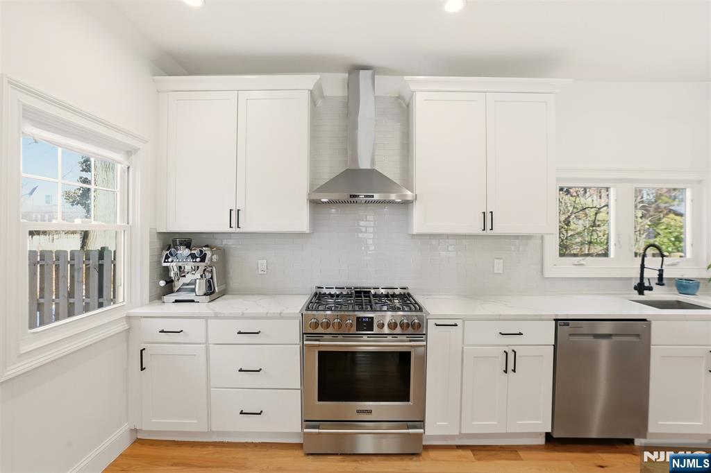 403 Lawn Ridge Road Orange, NJ 07050 - Photo 15 of 45 a kitchen with stainless steel appliances white cabinets and a stove