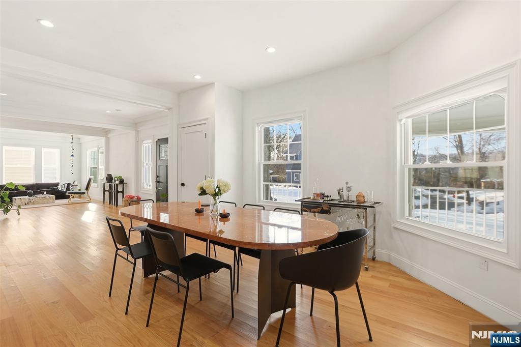 403 Lawn Ridge Road Orange, NJ 07050 - Photo 17 of 45 a dining hall with stainless steel appliances a dining table and chairs with wooden floor