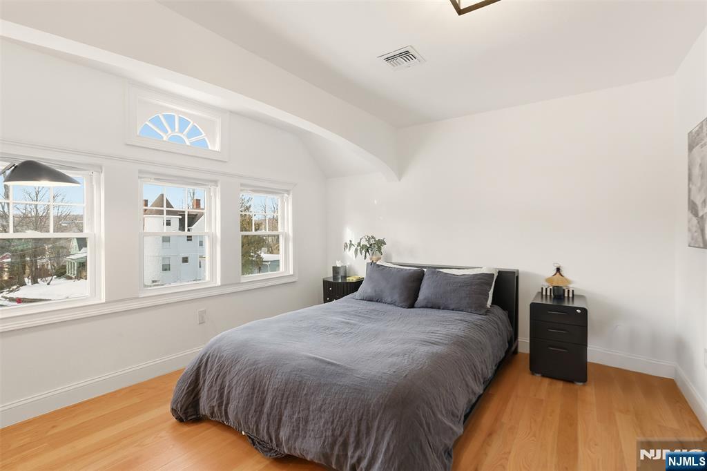 403 Lawn Ridge Road Orange, NJ 07050 - Photo 28 of 45 a bedroom with a bed and wooden floor