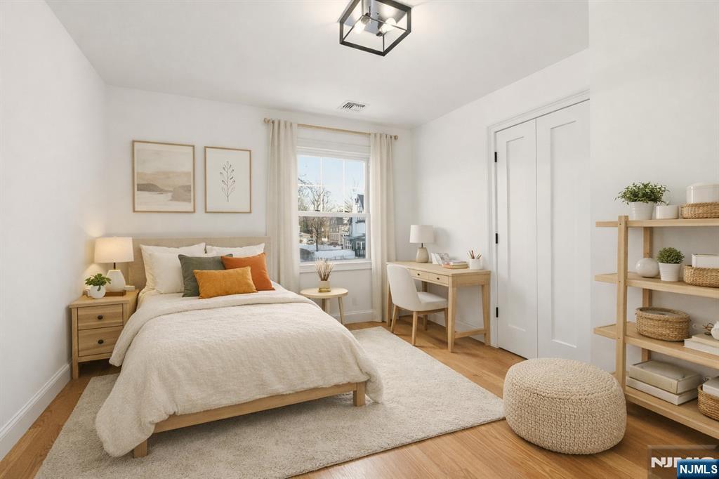 403 Lawn Ridge Road Orange, NJ 07050 - Photo 32 of 45 a bedroom with a bed and a chandelier