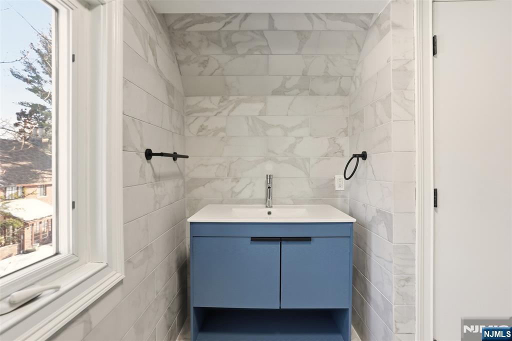 403 Lawn Ridge Road Orange, NJ 07050 - Photo 37 of 45 a bathroom with a sink and a mirror