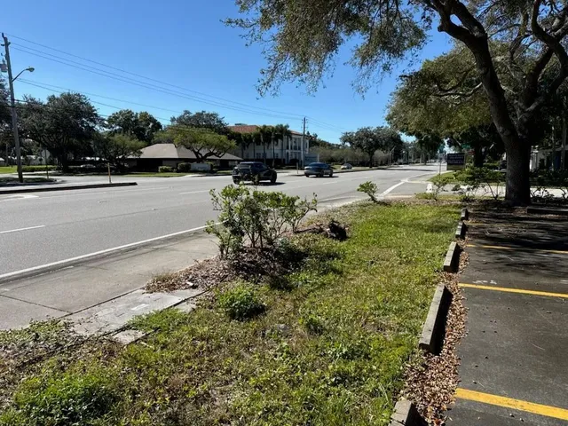 a view of a yard with wooden fence