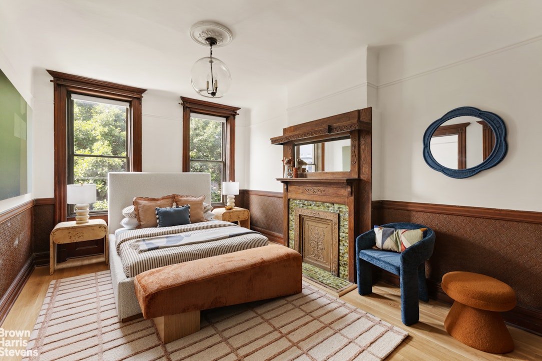 1456 Dean Street Brooklyn, NY 11213 - Photo 9 of 28 a bedroom with a bed a dresser and chair