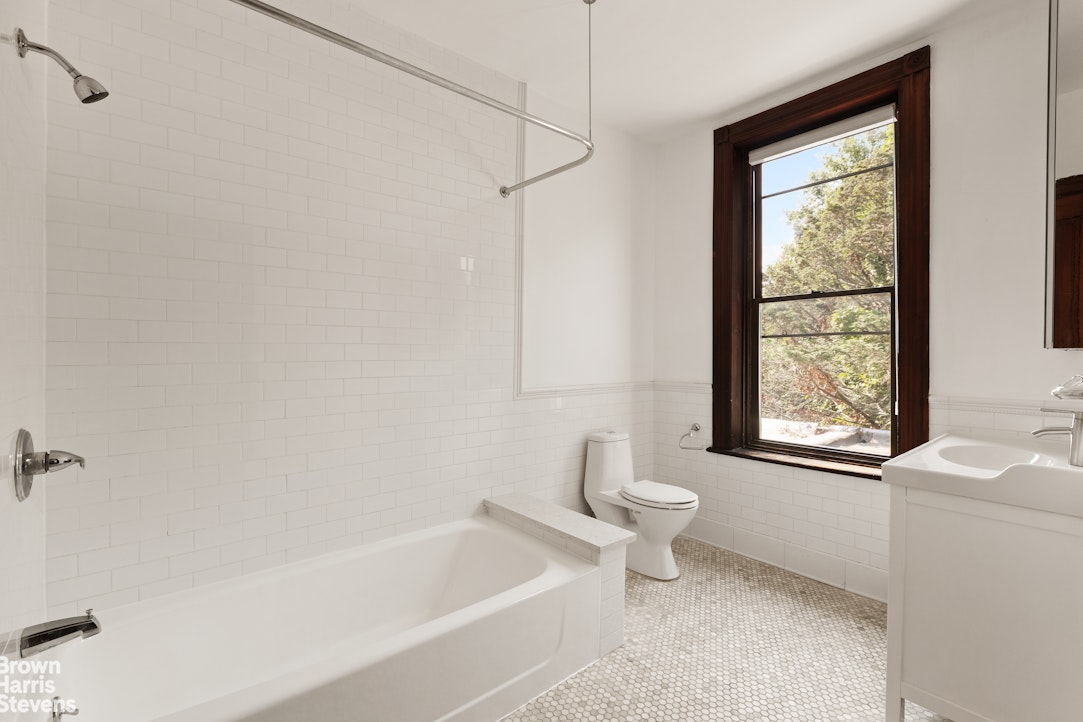 1456 Dean Street Brooklyn, NY 11213 - Photo 10 of 28 a bathroom with a bathtub a window and a shower