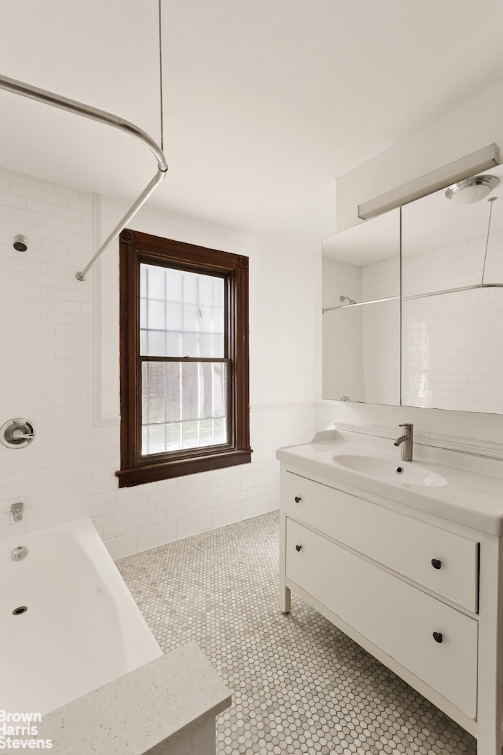 1456 Dean Street Brooklyn, NY 11213 - Photo 13 of 28 a spacious bathroom with a tub sink and mirror